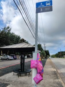 A photos of literal children's floaties hanging on a bus stop sign to illustrate the metaphor